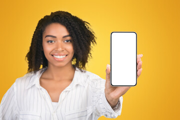 Poster - Mobile App Advertising. African woman showing blank cellphone screen, mockup, selective focus