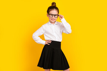 Sticker - Photo of cute schoolgirl hand touch eyeglasses wear uniform isolated on yellow color background