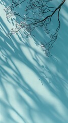 Poster - A tree branch casts a shadow on a blue background