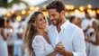 © LifeMedia - A blissful couple dances joyfully surrounded by friends and family at a beach wedding reception, radiating love, happiness, and the celebratory spirit of a special occasion.