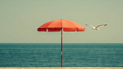 Wall Mural -   Seagull flying over the ocean next to a red umbrella on a red pole