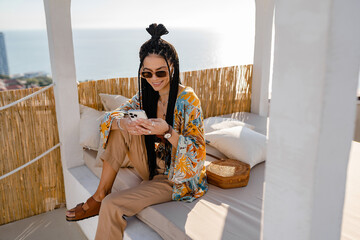 Wall Mural - stylish pretty woman with african braids on sunny summer vacation