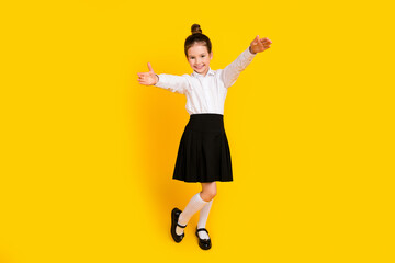 Sticker - Full size photo of cute schoolgirl raise arms welcome you wear uniform isolated on yellow color background