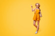 © Prostock-studio - Summer Fashion. Stylish Young Girl Wearing Straw Hat And Sunglasses Walking With Bag And Pointing At Copy Space On Yellow Background