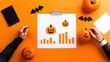 © Jammy - Creative workspace featuring Halloween-themed pumpkins and graphs on an orange background, perfect for festive marketing.