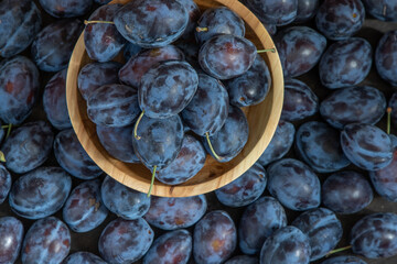 Plum variety Hungarian. Fruit harvest on the table in the kitchen. Autumn blue plum. Vitamin food bowl.