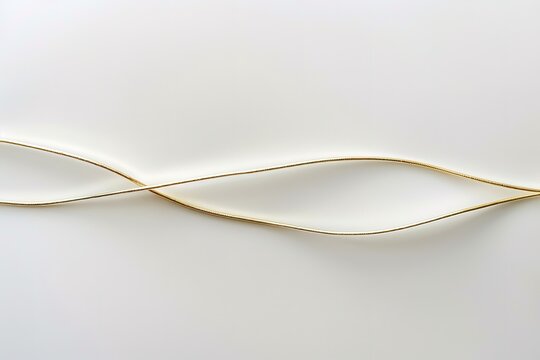 Two golden cords intertwine on a white background.