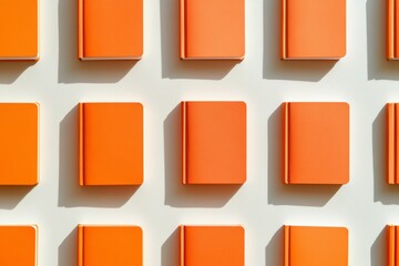 Poster - Bright Orange Notebooks on Soft White Background in Repetitive Graphy Pattern Evoking Crisp Sunny Day