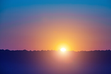 Wall Mural - a beautiful sunset with a bright orange sun in the sky
