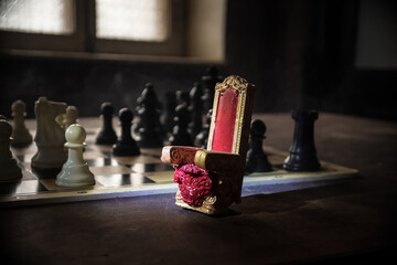 Wall Mural - Red royal chair miniature on wooden table. Medieval Throne on chessboard. Chess board game concept of business ideas and competition and strategy ideas concept. Selective focus