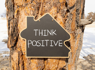 Wall Mural - Think positive symbol. Concept words Think positive on beautiful black house blackboard. Beautiful tree background. Business, motivational think positive thinking concept. Copy space.