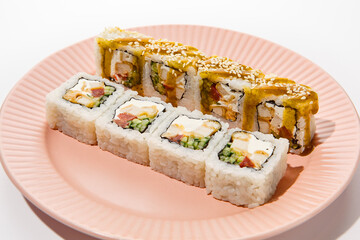 Wall Mural - Tempura Chicken and Vegetable Sushi Roll with Curry Sauce on Pink Plate