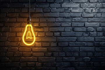 Wall Mural - A light bulb is lit up against a brick wall. The light is shining on the wall, creating a warm and inviting atmosphere. The brick wall adds a sense of texture and depth to the scene