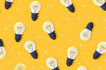 Wall Mural - A yellow background with many light bulbs hanging from the ceiling. The light bulbs are of different sizes and colors. Concept of creativity and inspiration