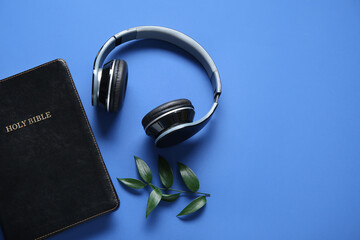 Sticker - Holy Bible with branch of eucalyptus and earphones on blue background