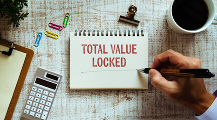 There is notebook with the word Total Value Locked. It is as an eye-catching image.