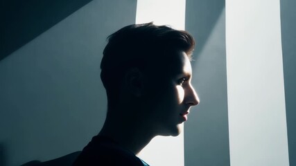 Poster - Young businessman in an office, bathed in sunlight, lost in contemplation, exuding confidence and determination