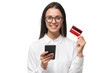 © Damir Khabirov - Woman holding phone and credit card, ready to purchase goods with new app