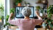 © Lens Legacy - An elderly woman engages in a fitness routine, exercising indoors by following an online workout class on her TV, fostering health and well-being in a comfortable setting.
