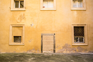 Old door in yellow wall