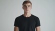 © Zie - Young Man in a Black T-Shirt Against a White Background