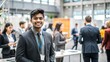 © N7 - An Indian student attending a career fair or networking event at a university, with booths and professionals in the background.