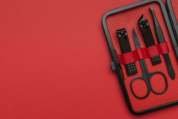 Red Manicure Kit with Scissors, Clippers, and Tweezers on Matching Background