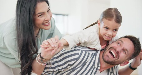 Wall Mural - Happy, playful and young parents with child in the living room together at modern family home. Smile, adventure and mother and father playing with girl kid in the lounge at a house in Canada.