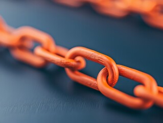 Close-up of a vibrant orange chain link, showcasing its texture and details against a dark background.