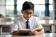 © N7 - 'Indian Schoolboy with Glasses Studying' - A focused Indian boy wearing glasses, intently studying his textbook.