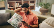 © peopleimages.com - Man, phone and stress in home with mistake, loss and online gambling with debt on couch in living room. Person, smartphone and worry with risk, frustrated and confused with mobile app in Colombia