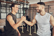 © Van Wyk/peopleimages.com - Happy man, friends and handshake with fitness partner for success, workout or teamwork together at gym. Young male person or men shaking hands with smile for training, goal or exercise at health club