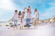 © peopleimages.com - Happy, big family and outdoor at beach, fun and grandparents on vacation with group for bonding. Sea, woman and man with kids for holiday with senior people, summer and break for children in Canada