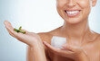 © Michael Cunningham/peopleimages.com - Face cream, hands or woman with plant for beauty on white background with herbs, product or glow. Aloe vera leaf, closeup or happy girl in studio with natural cosmetics, hydration or collagen results