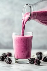 Sticker - A refreshing purple smoothie being poured into a glass, surrounded by blackberries.