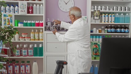 Sticker - Elderly grey-haired man in a pharmacy wearing a white coat, organizing and examining products on the shelf in a well-stocked drugstore interior.