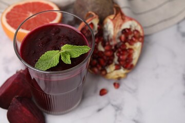 Wall Mural - Fresh beetroot smoothie with mint in glass on white marble table, closeup. Space for text