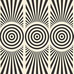 A striking black and white optical illusion pattern featuring concentric circles and radial lines. The high-contrast design creates a mesmerizing effect