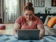 © Mikhail Vorobev - Overweight woman doing online fitness training at home, following workout on laptop in living room
