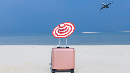 The Pink luggage on the beach- summer travel concept