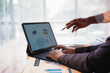 © amnaj - Business team working together, analyzing financial data on a tablet computer and developing a business strategy