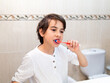 © javidestock - Young boy brushing teeth in bathroom