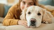 © Anurak - Closeup of a Golden Retriever and a Girl's Hand.