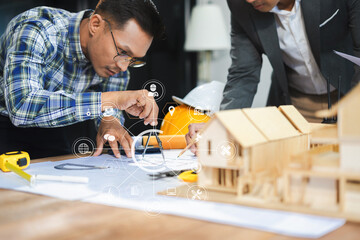 Wall Mural - Businessman working as a team discussing data working and tablet, laptop with on architectural project at construction site at desk in office.