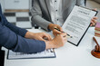 © NINENII - Business people and lawyers discussing contract papers sitting in the table at office, concepts of law, advice, legal services.