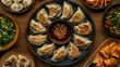 © ALIS ST - Top view of Korean dumplings (mandu) with a variety of fillings and dipping sauce. Great for recipe shares