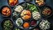 © ALIS ST - Top view of Korean dumplings (mandu) with a variety of fillings and dipping sauce. Great for recipe shares