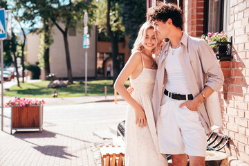 Smiling beautiful woman and her handsome boyfriend. Woman in casual summer clothes. Happy cheerful family. Female having fun. Couple posing in the street it sunny day. Cheerful and happy