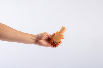 Wall Mural - Cosmetic cream tube in womans hand on white background 