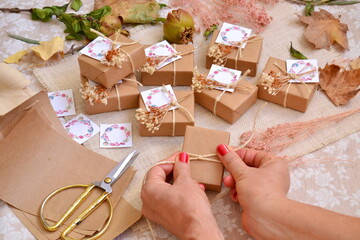 Wall Mural - Autumn wedding favors making process woman hands crafting wrapping and decorating gift box with jute ribbon, artisan handmade small guest souvenirs, homemade presents fall rustic style decor